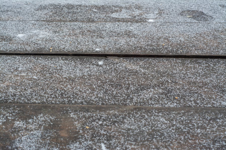 The texture of the wooden surface covered with snowの写真素材