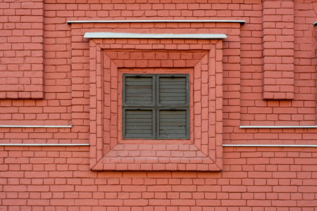 Shuttered window in decorative brick wallの写真素材