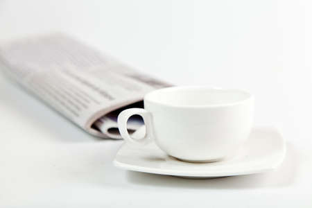 white coffee cup and newspaper isolated on whiteの写真素材