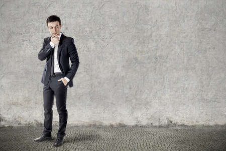 portrait of young businessman on grunge backgroundの写真素材
