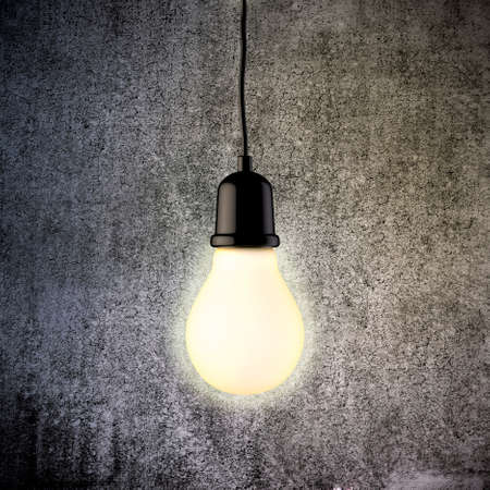 3d light bulb on vintage concrete wall
