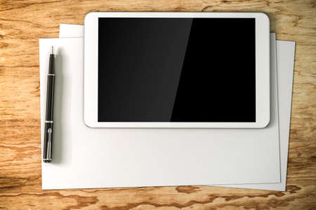 3d work place setup with digital tablet and documentsの写真素材