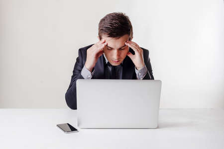 Close up image of multitasking business man using a laptop and mobile phoneの写真素材