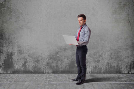 business man  standing against vintage wallの写真素材