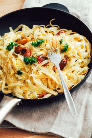 Delicious tagliatelle pasta in a cast iron skilletの写真素材