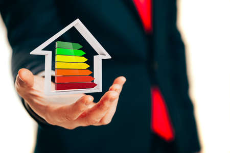 Business man holding an efficiency performance scale, conceptの写真素材