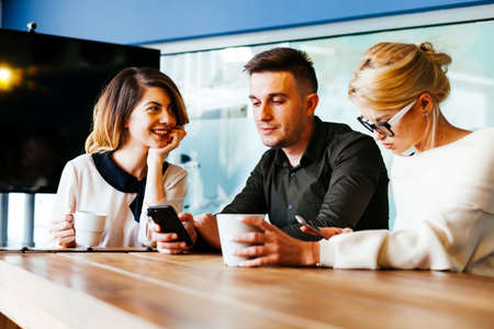 Casual discussion between coworkers in modern office roomの写真素材