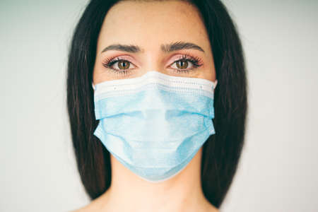 beautiful woman model wearing a facial medical maskの写真素材