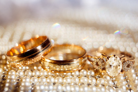 Wedding rings close up on shining backgroundの写真素材