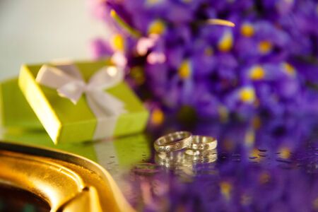 Bridal bouquet of irises and wedding rings.