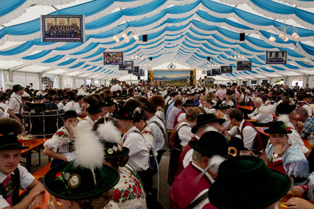 Traditional German Festival with People Seated on Benches in large Festival Tentのeditorial素材