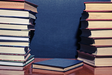 books on wooden deck tabletop against grunge board, copyspace for your textの写真素材