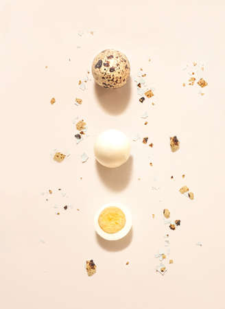 Minimal concept of three different organic natural quail eggs. Flat lay arrangement made with beige...