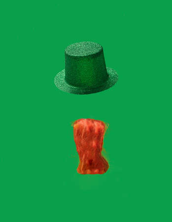 St. Patrick's Day concept. Irish glittery hat and  ginger curly beard on green background.の写真素材