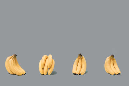Pattern made of fresh bunch of organic bananas. Arrangement with trendy ultimate gray backgroundの写真素材