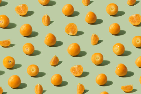 Golden berries pattern on light pastel green background.の写真素材