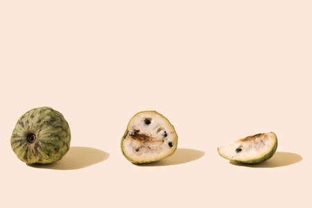 Yummy three piese of exotic cherimoya fruit, half and slice on ivory background.の写真素材