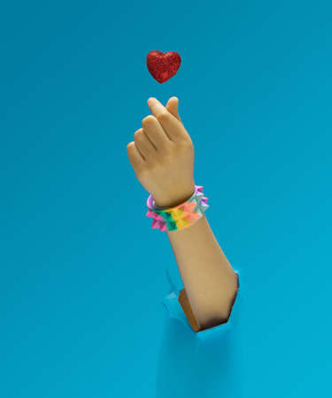 K pop concept. A girl hand with rainbow pyramid studded bracelet showing fingers heart gesture. Red glittery heart above. Optimistic blue in background.の写真素材