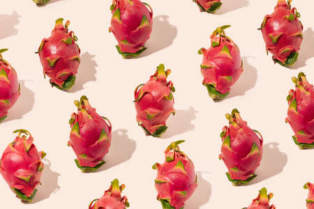 Authentic pattern made of exotic delicious dragon fruit. Gentle pink color background.