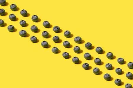 Minimal pattern of  three lines on diagonal of organic natural blueberries. Arrangements made with...
