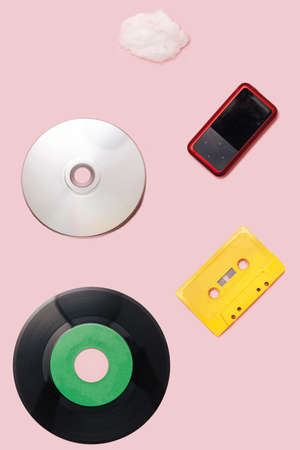 Music mediums over time concept. EP and LP vinyl, cassette tape, CD, mp3 player, cell phone,...