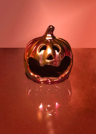 Halloween futuristic pumpkin scary minimal arrangement. Creepy minimal terracotta sparkling backgroundの写真素材
