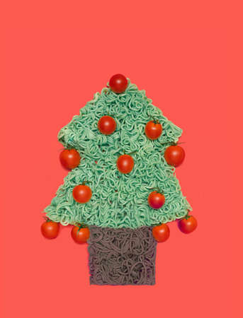 Healthful oriental eats concept. Tree look like shape dish with green noodles in it and organic cherry tomato. Flat lay arrangementの写真素材