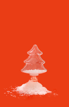 Cool winter christmas tree inspired concept. Snowflakes fall down. Minimal red optimistic background.の写真素材