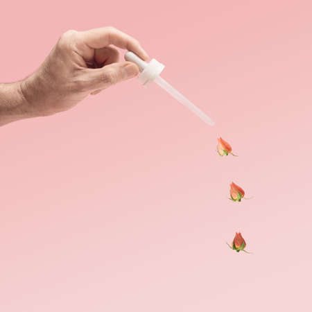 Common skincare cosmetic pipette dropper inspired concept. Male hand hold pipette with three little...