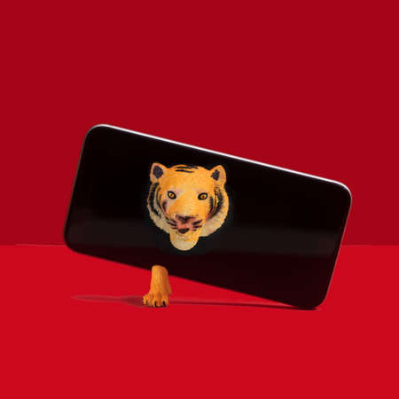 Tiger breaks through out of the mobile phone. Minimal concept of Chinese zodiac new year. Red...