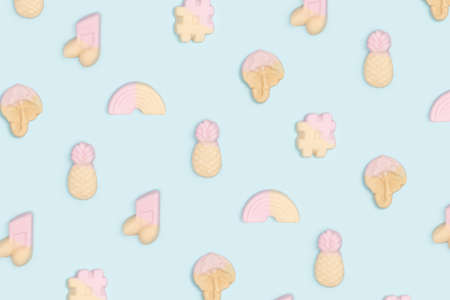 Flat lay pattern arrangement made of yummy jelly soft pop bonbons. Aqua blue background