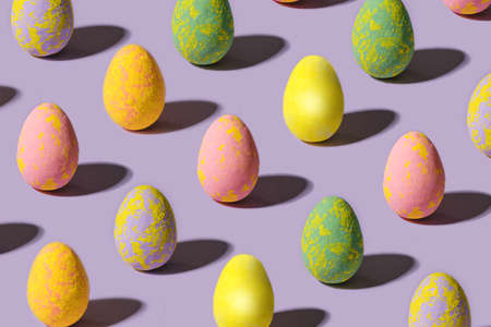 Charming abstract easter minimal concept. Lovely broken pattern made of unique colored eggs against...