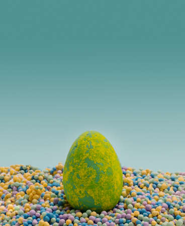 Funky minimal Easter concept.  Unique colored eggs lay down on many colorful little balls. Creative copy space above with blue background.の写真素材