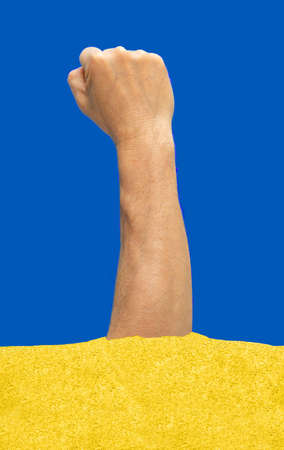 Man hand clenched in fist up in the air with blue and yellow colors in background. Raised up fist....