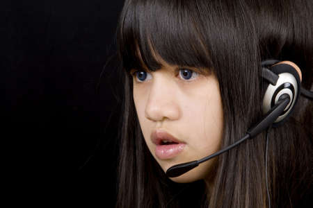 Teenager communicates by means of headsetの写真素材