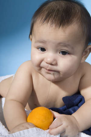 Baby with orangeの写真素材