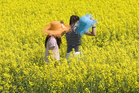 Teenagers in the rape field photographed at spring time