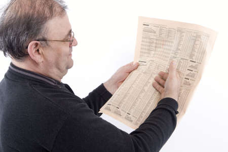 Senior reads newspaperの写真素材