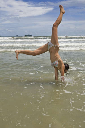 female teenager jumps on the beach