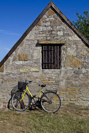 Bicycle with old stone house, in Snogebaek, Denmarkの写真素材