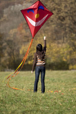 fly a kite, teenager in fall weather in natureの写真素材