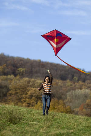 fly a kite, teenager in fall weather in natureの写真素材