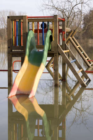 Playground under water, child slide is mirrored in the waterの写真素材