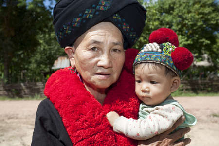 Portrait woman Asia with baby, ethnic group Yaoの写真素材