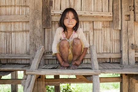Asian girl Akha before timber houseの写真素材