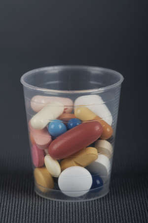 Mug with drugs, choice of coloured tabletsの写真素材