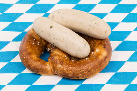 Bavarian pretzel with white sausage, traditional food at munich Oktoberfest