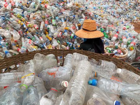 Ban Na Namchum, Thailand - May 10, 2019: Thai workers clean empty plastic bottles with hand for...