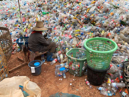 Ban Na Namchum, Thailand - May 10, 2019: Thai workers clean empty plastic bottles with hand for...