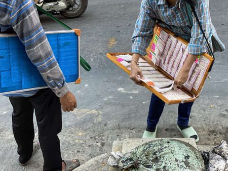Bangkok, Thailand - December 11, 2019:  Lottery is very popular in Thailand and the relationship is every two weeks. Street vendors offer lottery ticketsのeditorial素材